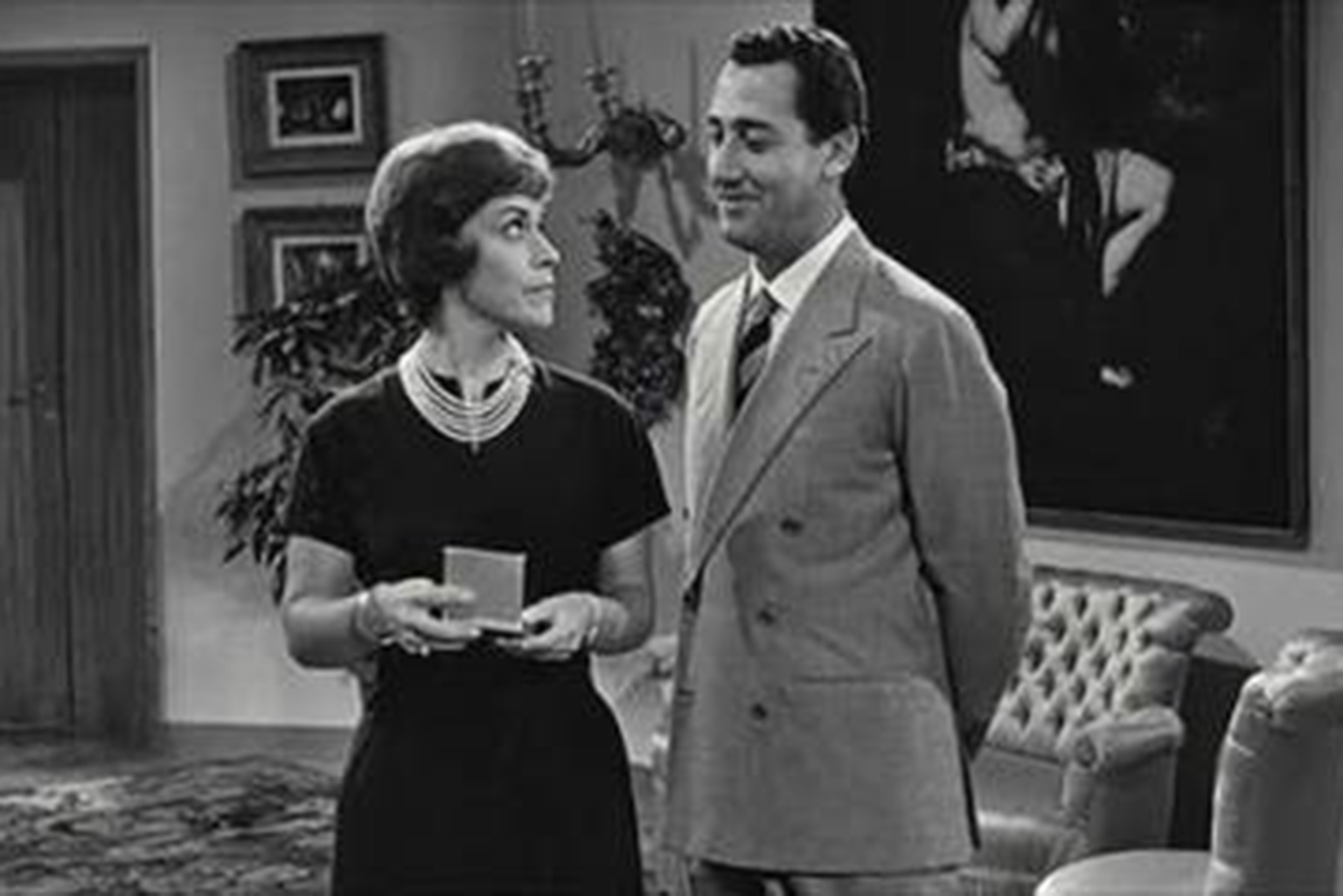 a man standing next to a woman in a living room.