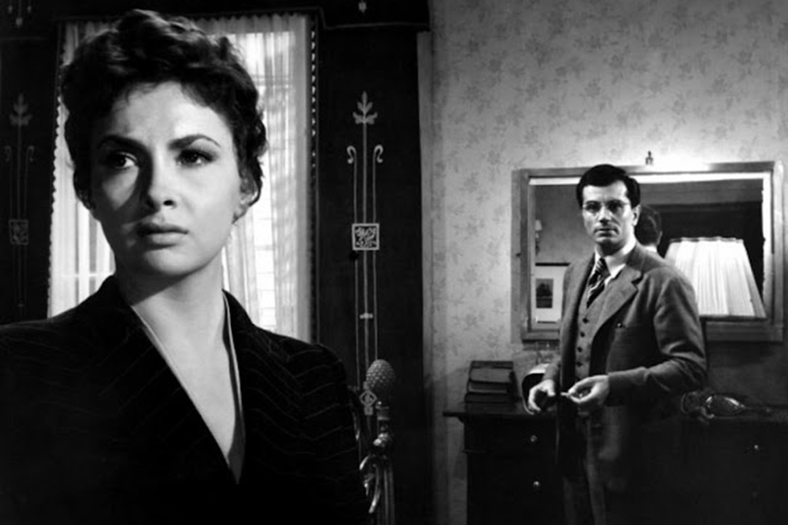 a man and a woman standing in a room.