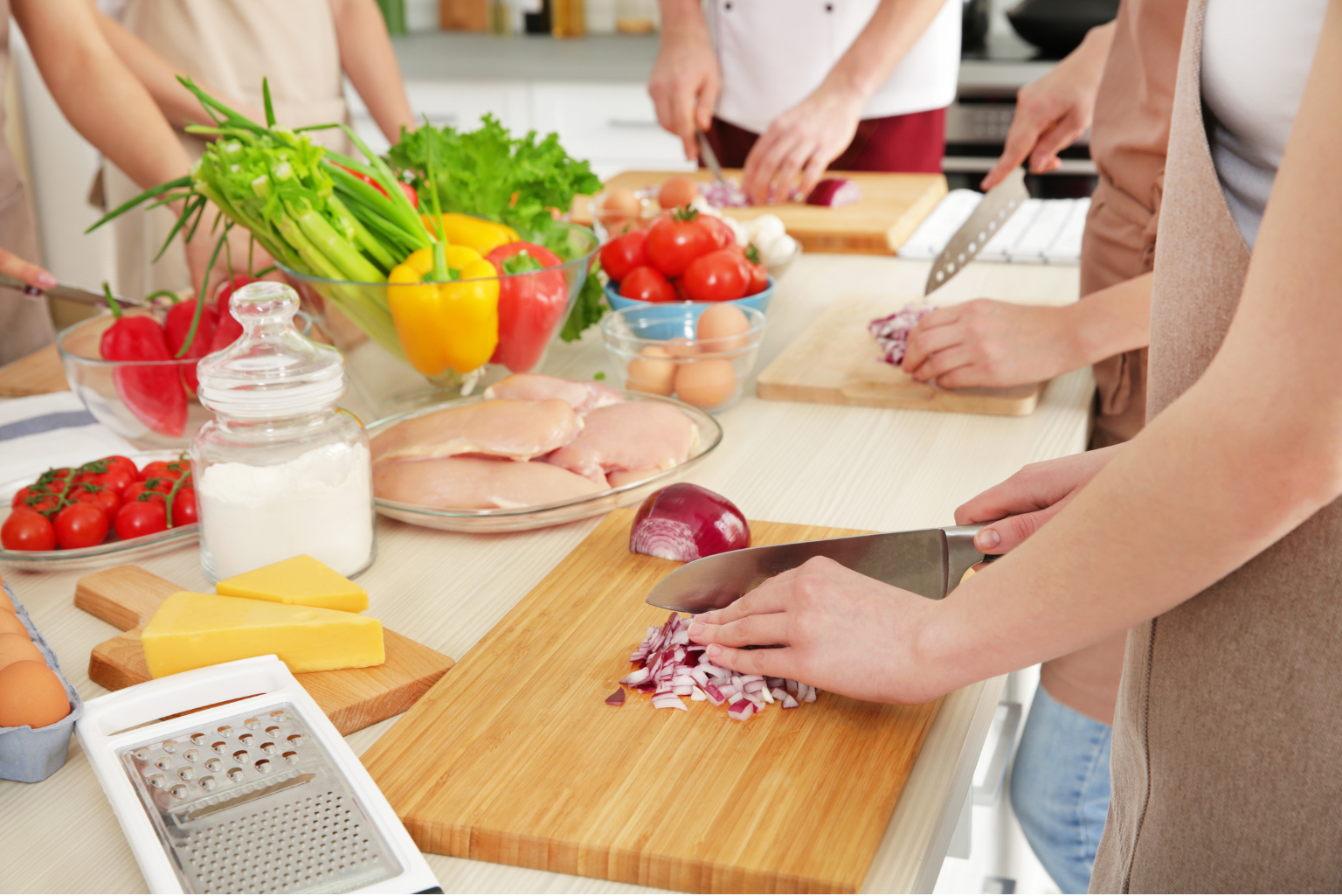 a group of people preparing food on a counter top.